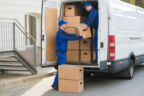 Student removals van near Soho street with luggage and boxes