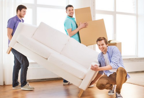 Household items being carried down stairs during a Soho property move