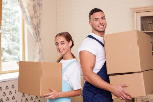 Careful lifting and carrying of a boxed item during transport