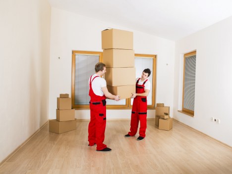 Mover wearing PPE while carrying boxes